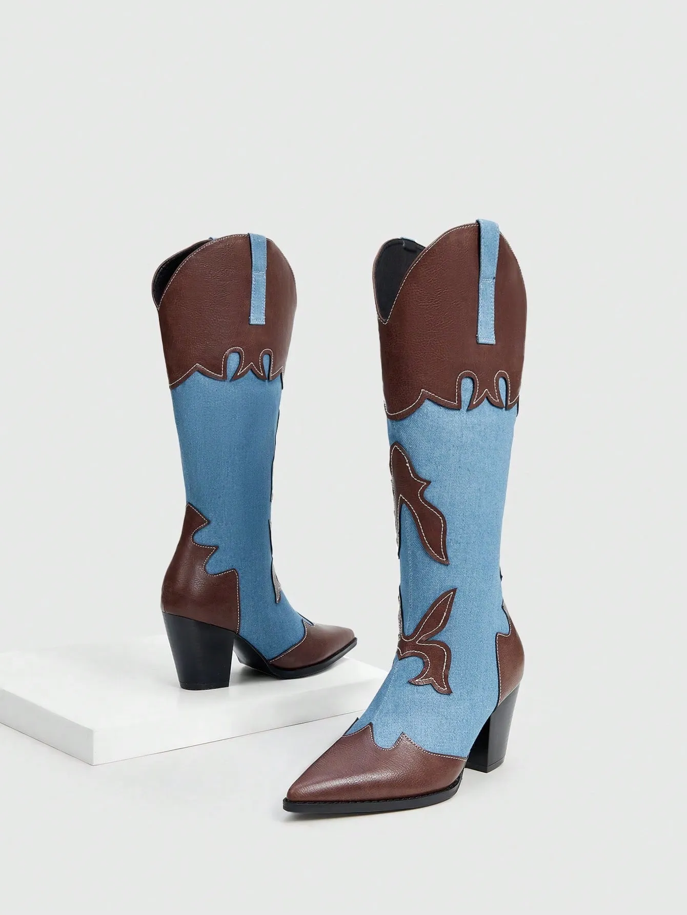 Fashionable and comfortable women's western boots with contrasting colors, pointed toe, and block heel