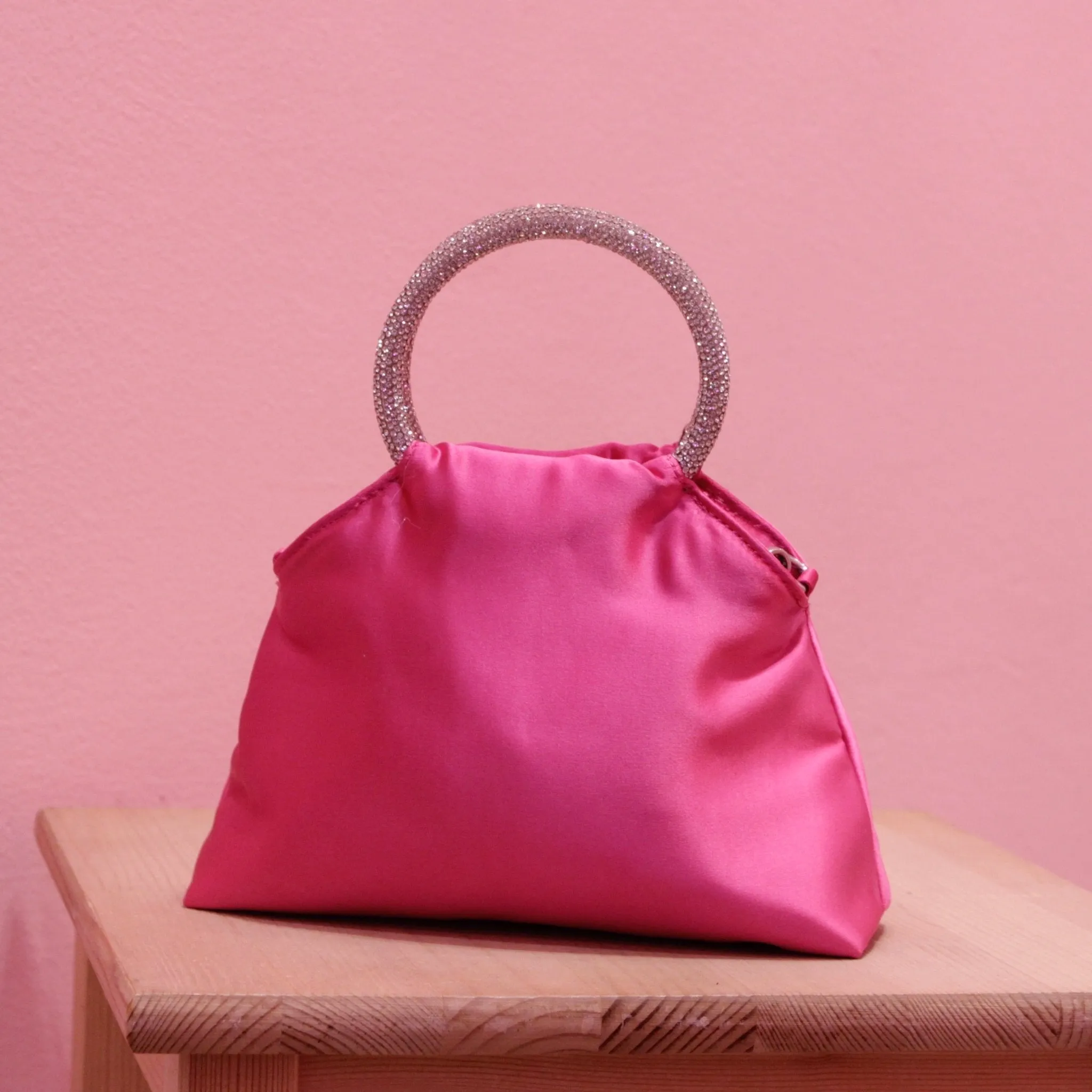 Fuchsia satin puffer bag with jewel handles