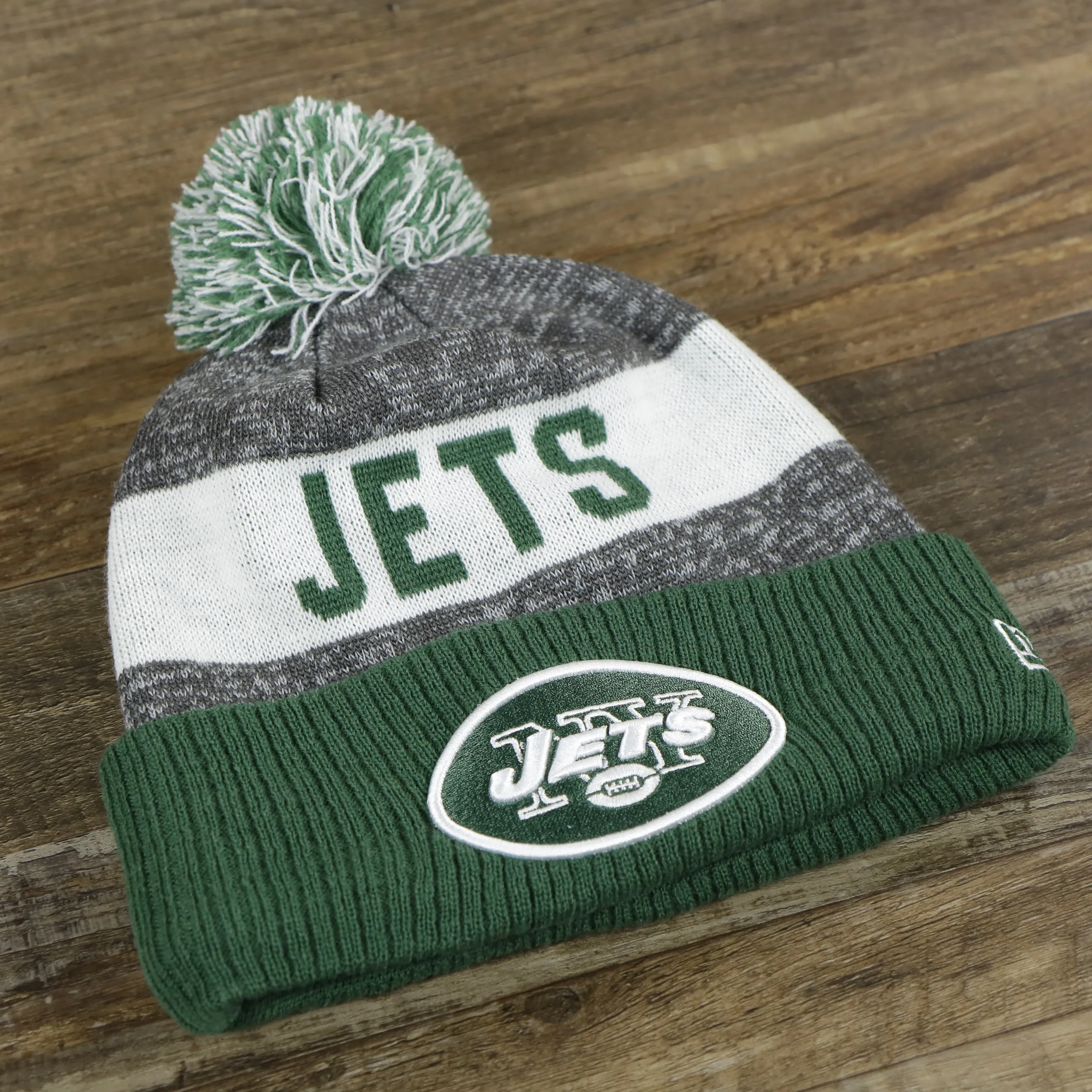 New York Jets Pom Pom Winter Beanie - Green and Gray, On-Field Striped Wordmark.