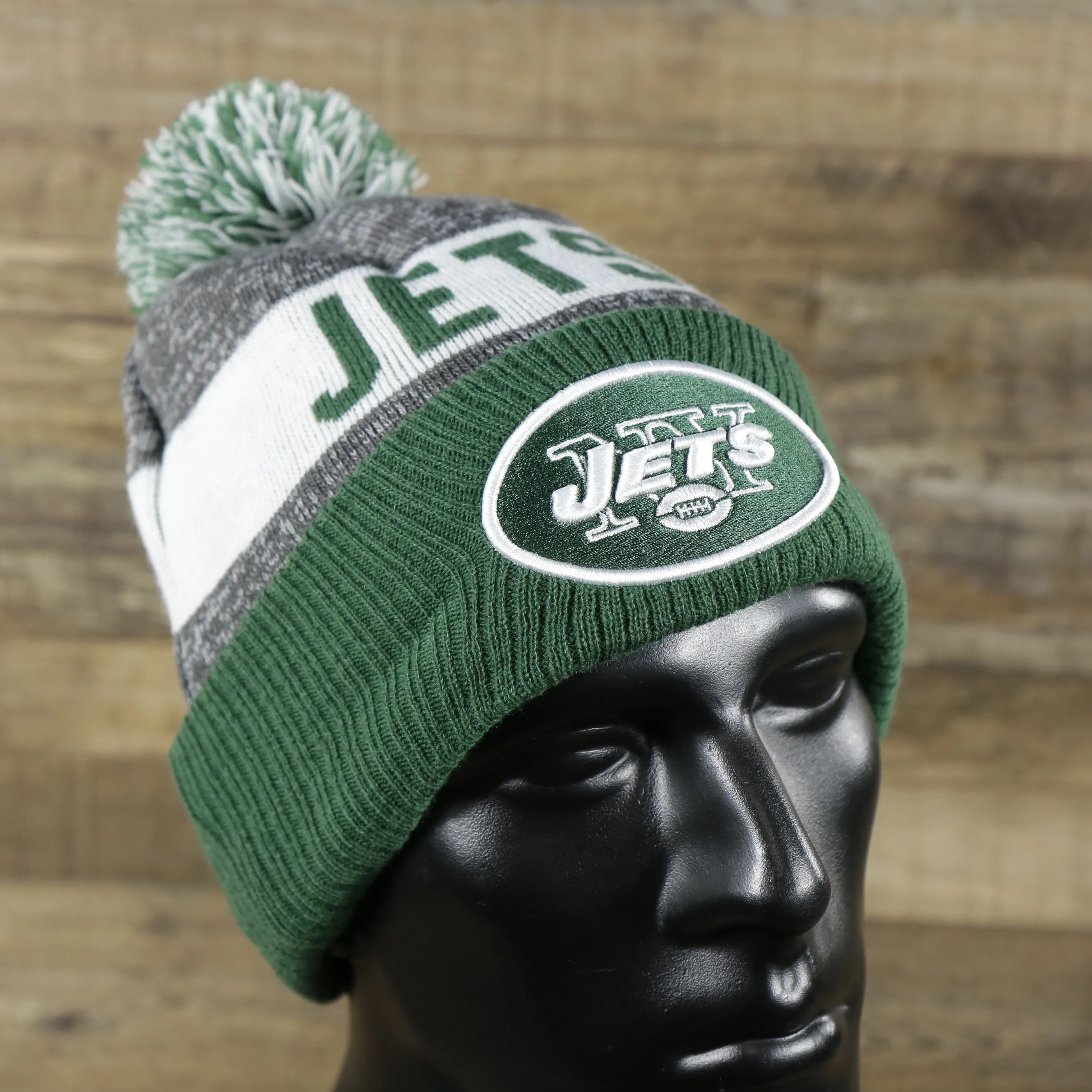 New York Jets Pom Pom Winter Beanie - Green and Gray, On-Field Striped Wordmark.