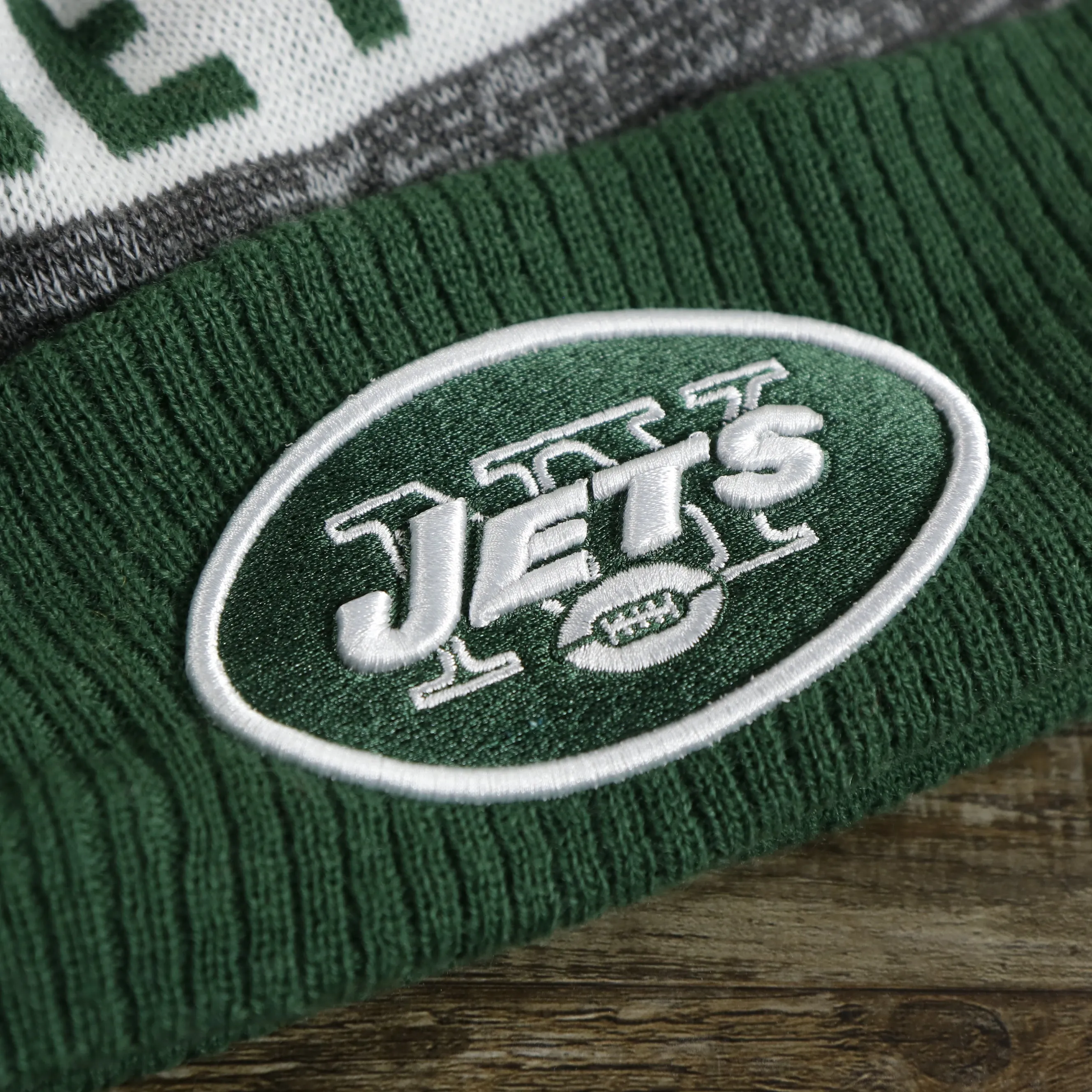 New York Jets Pom Pom Winter Beanie - Green and Gray, On-Field Striped Wordmark.