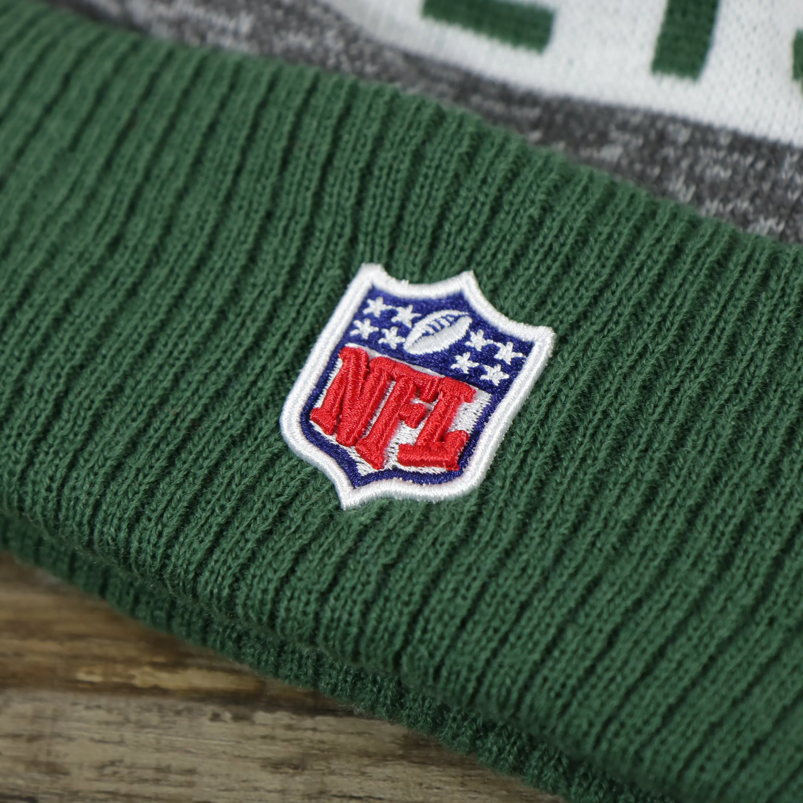 New York Jets Pom Pom Winter Beanie - Green and Gray, On-Field Striped Wordmark.