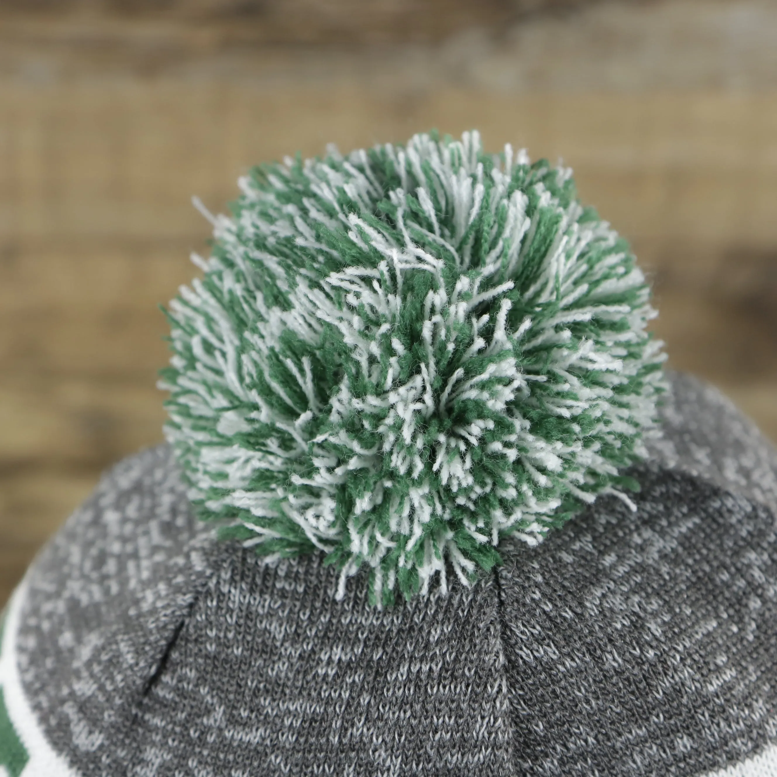 New York Jets Pom Pom Winter Beanie - Green and Gray, On-Field Striped Wordmark.